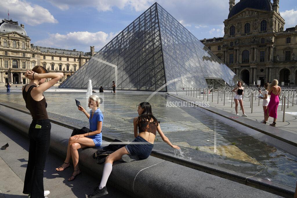 Francois Mori Visitors take a break outside the Louvre Museum courtyard, in Paris, Wednesday, June 9, 2021. France is back in business as a tourist destination after opening its borders Wednesday to foreign visitors who are inoculated against the coronavirus with vaccines approved by the European Union's medicines agency. France's acceptance of only the Pfizer, Moderna, AstraZeneca and Johnson & Johnson vaccines means that tourism is still barred for would-be visitors from China and other countries that use other vaccines. (AP Photo/Francois Mori)