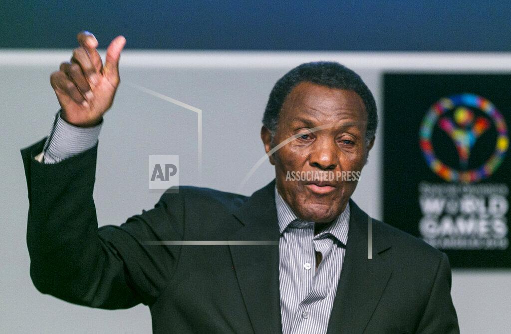 Damian Dovarganes FILE - In this July 20, 2015, file photo, Olympic gold medalist and philanthropist Rafer Johnson lifts his arm to mimic the lighting of the Olympic torch as he recalls the first Special Olympics World Games he attended, during a news conference in Los Angeles. Rafer Johnson, who won the decathlon at the 1960 Rome Olympics and helped subdue Robert F. Kennedy's assassin in 1968, died Wednesday, Dec. 2, 2020. He was 86. He died at his home in the Sherman Oaks section of Los Angeles, according to family friend Michael Roth.(AP Photo/Damian Dovarganes)