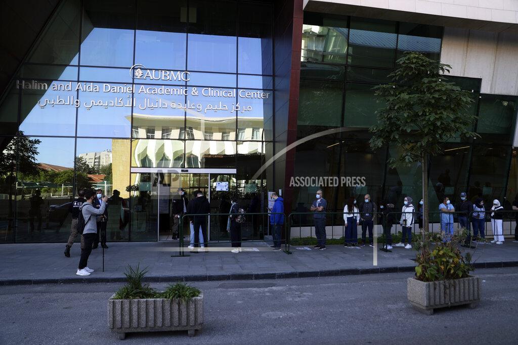 Bilal Hussein Frontline medical workers stand in line to get the Pfizer-BioNTech COVID-19 vaccine during a nationwide vaccination program at the American University Medical Center in Beirut, Lebanon, Sunday, Feb. 14, 2021. (AP Photo/Bilal Hussein)