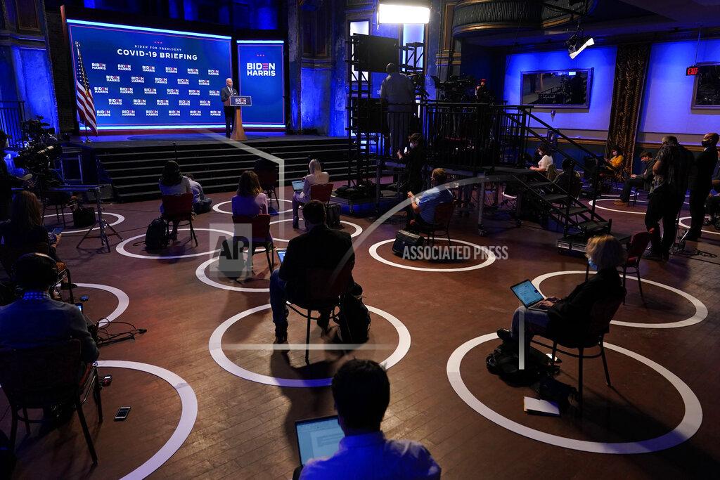 Patrick Semansky FILE - In this Sept. 1, 2020, file photo journalists sit in socially-distant circles as Democratic presidential candidate former Vice President Joe Biden speaks after participating in a coronavirus vaccine briefing with public health experts in Wilmington, Del. (AP Photo/Patrick Semansky, File)