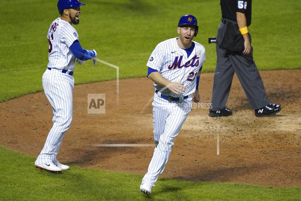John Minchillo New York Mets' Todd Frazier celebrates after scoring on a sacrifice fly by Andres Gimenez off Philadelphia Phillies pitcher Spencer Howard during the fourth inning of a baseball game, Saturday, Sept. 5, 2020, in New York. (AP Photo/John Minchillo)