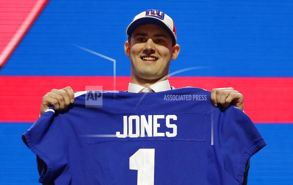 Mark Humphrey Duke quarterback Daniel Jones poses with his new jersey after the New York Giants selected Jones in the first round at the NFL football draft, Thursday, April 25, 2019, in Nashville, Tenn. (AP Photo/Mark Humphrey)