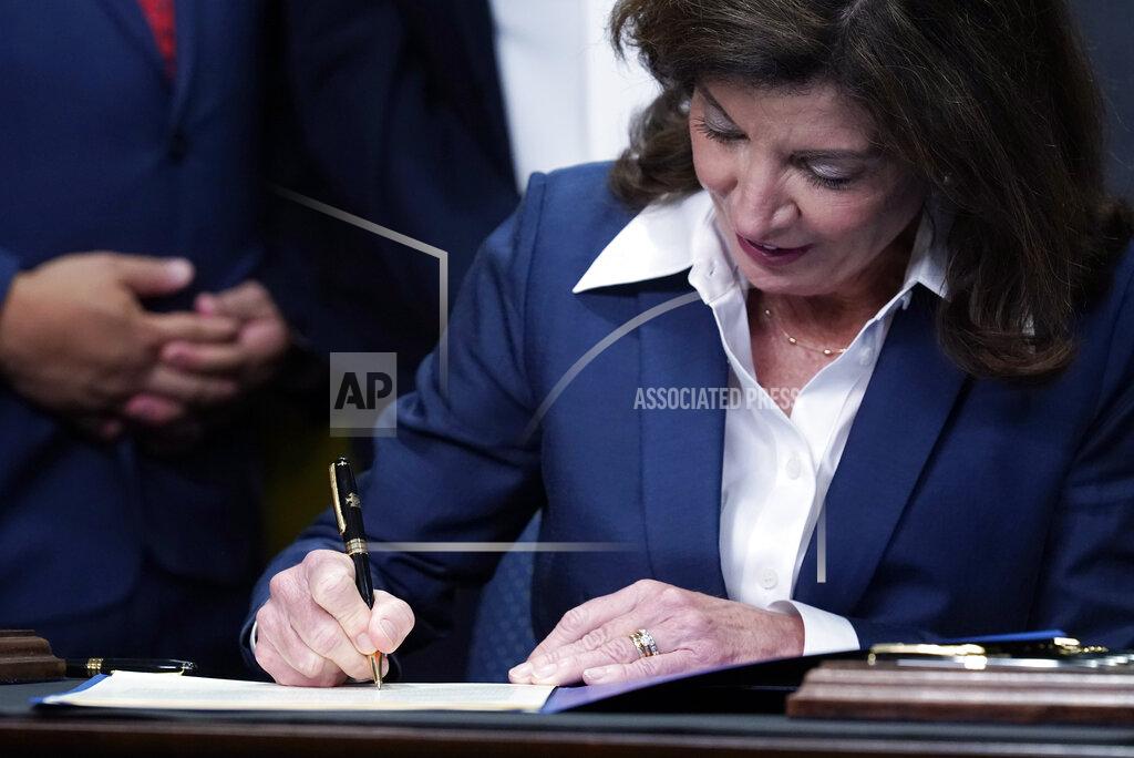 Richard Drew New York Gov. Kathy Hochul signs the "Less is More" law, during ceremonies in the governor's office, in New York, Friday, Sept. 17, 2021. New Yorkers will be able to avoid jail time for most nonviolent parole violations under a new law that will take effect in March, and largely eliminates New York's practice of incarcerating people for technical parole violations. (AP Photo/Richard Drew)