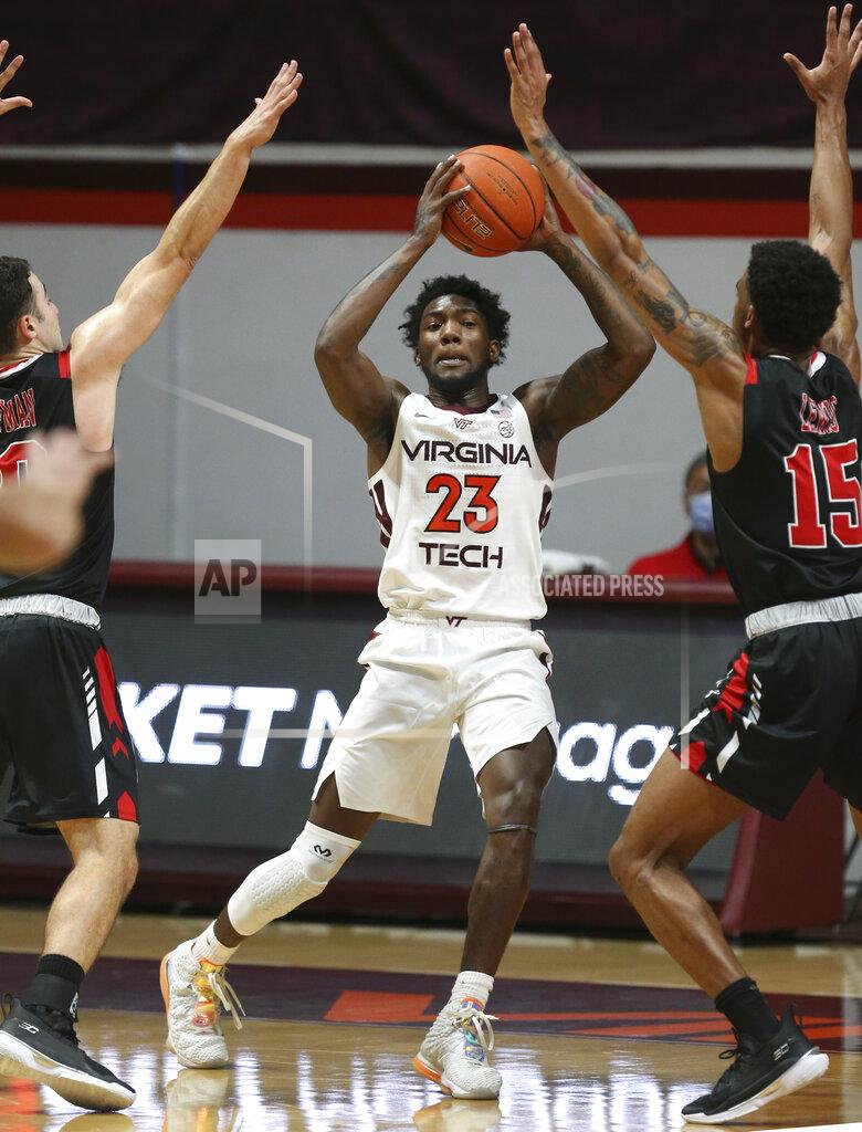 Matt Gentry Virginia Tech's Tyrece Radford looks to pass while guarded by VMI defenders during the second half of an NCAA college basketball game, Thursday, Dec. 3, 2020 in Blacksburg, Va. (Matt Gentry/The Roanoke Times via AP, Pool)