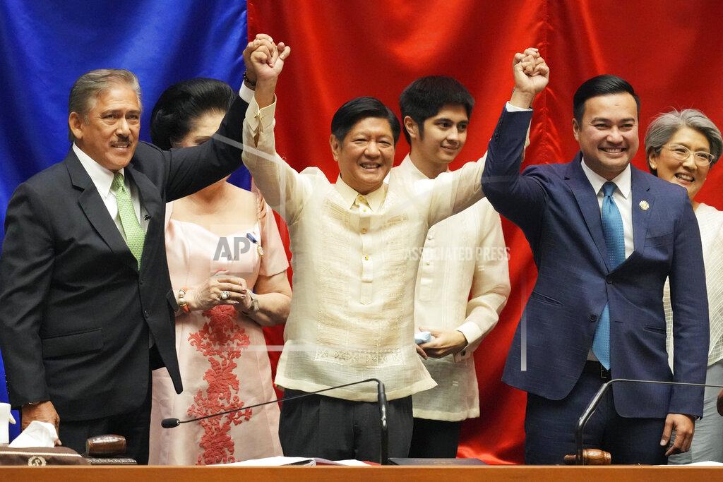 Aaron Favila President-elect Ferdinand 'Bongbong" Marcos Jr. raises hands with Senate President Vicente Sotto III, left, and House Speaker Lord Allan Velasco during his proclamation at the House of Representatives, Quezon City, Philippines on Wednesday, May 25, 2022. Marcos Jr. was proclaimed the next president of the Philippines by a joint session of Congress Wednesday in an astonishingly huge electoral triumph 36 years after his father was ousted as a brutal dictator by a pro-democracy uprising. (AP Photo/Aaron Favila)