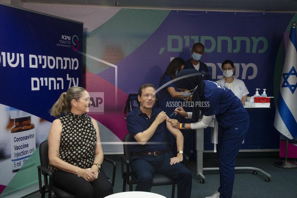 Maya Alleruzzo Israeli President Isaac Herzog receives a third coronavirus vaccine injection while his wife, Michal, left, reacts, at the Sheba Medical Center in Ramat Gan, Israel, Friday, July 30, 2021. (AP Photo/Maya Alleruzzo, Pool)