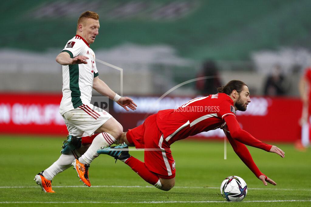 Laszlo Balogh Poland's Grzegorz Krychowiak, right falls in front of Hungary's Laszlo Kleinheisler during the World Cup 2022 group I qualifying soccer match between Hungary and Poland at the Puskas Arena in Budapest, Hungry Thursday March 25, 2021. (AP Photo/Laszlo Balogh)