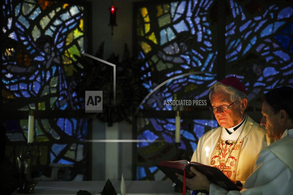 John Locher Bishop George Leo Thomas, left, gives an Easter Vigil Mass beside Deacon Rick Minch live-streamed from a small chapel without worshipers due to the coronavirus outbreak, Saturday, April 11, 2020, in Las Vegas. (AP Photo/John Locher)