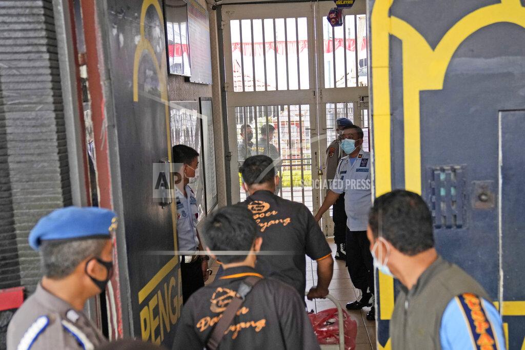 Dita Alangkara Staff and police officers guard the main entrance gate of Tangerang prison in Tangerang on the outskirts of Jakarta, Indonesia, Wednesday, Sept. 8, 2021. A massive fire raged through the overcrowded prison early Wednesday, killing a number of inmates. (AP Photo/Dita Alangkara)