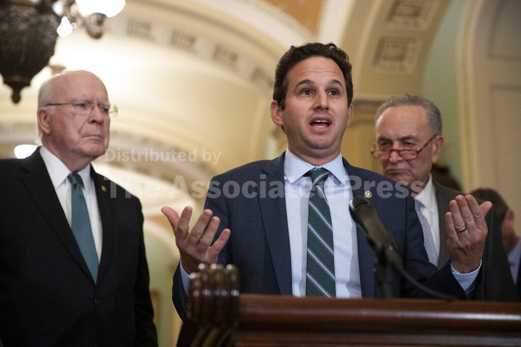 Sen. Patrick Leahy, D-Vt., left, and Senate Minority Leader Chuck Schumer of N.Y., right, listen as Sen. Brian Schatz, D-Hawaii, speaks about the coronavirus, Tuesday, March 3, 2020 in Washington. (AP Photo/Alex Brandon)