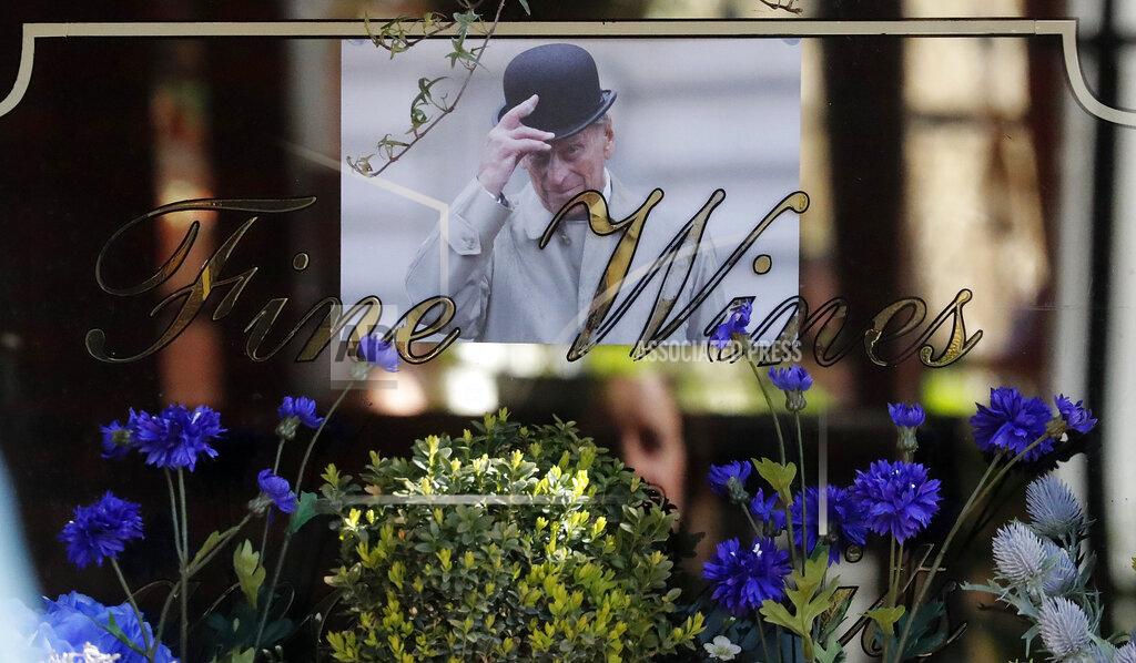 Frank Augstein A picture of Britain's Prince Philip is placed in a pub's window in Windsor, England, Thursday, April 15, 2021. Britain's Prince Philip, husband of Queen Elizabeth II, died Friday April 9 aged 99. His funeral service will take place on Saturday at Windsor Castle. (AP Photo/Frank Augstein)
