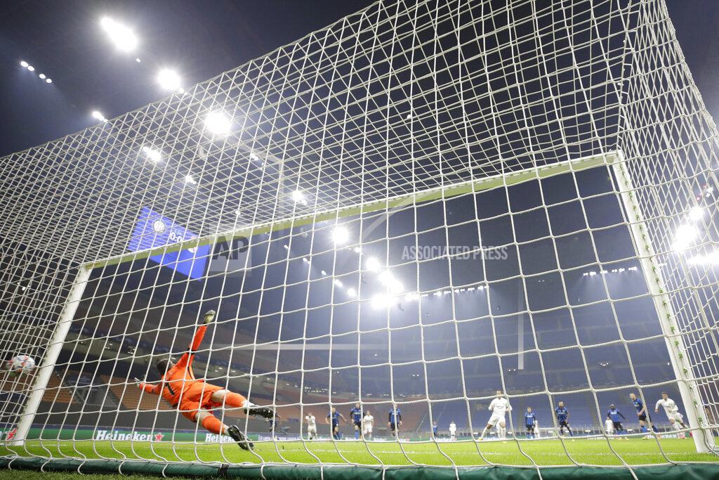 Luca Bruno Real Madrid's Eden Hazard, background center, scores on a penalty kick during the Group B, Champions League soccer match between Inter Milan and Real Madrid at the San Siro Stadium, in Milan, Italy, Wednesday, Nov. 25, 2020. (AP Photo/Luca Bruno)