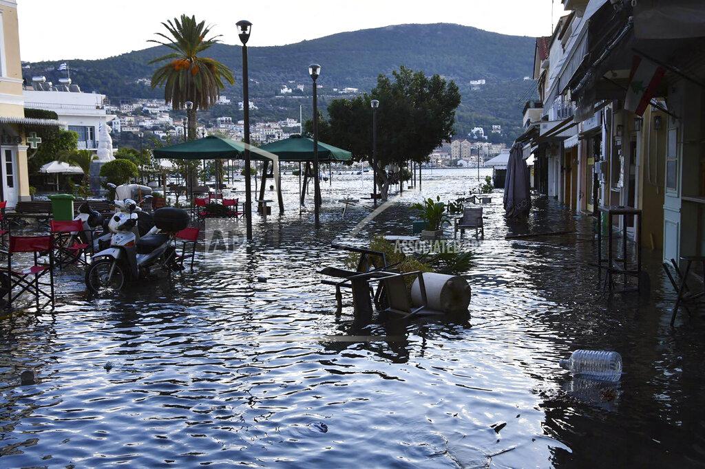 Michael Svarnias Seawater covers floods a square after an earthquake at the port of Vathi on the eastern Aegean island of Samos, Greece, Friday, Oct. 30, 2020. A strong earthquake struck in the Aegean Sea between the Turkish coast and the Greek island of Samos as the magnitude 6.6 earthquake was centered in the Aegean at a depth of 16.5 kilometers, or 10.3 miles.(AP Photo/Michael Svarnias)