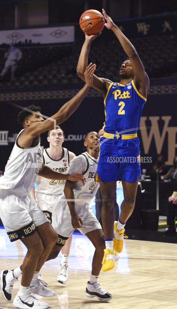Walt Unks Pittsburgh's Femi Odukale (2) puts up a jumper over Wake Forest's Emmanuel Okpomo during an NCAA college basketball game Saturday, Jan. 23, 2021, in Winston-Salem, N.C. (Walt Unks/The Winston-Salem Journal via AP)