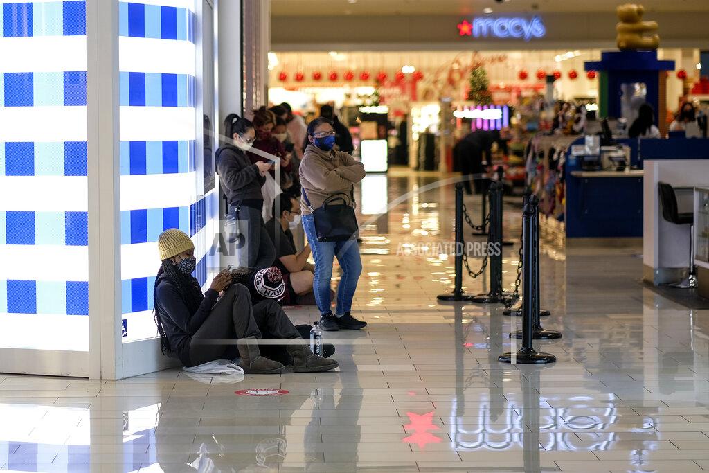 Ringo H.w. Chiu Black Friday shoppers wearing face masks wait in line to enter a store at the Glendale Galleria in Glendale, Calif., Friday, Nov. 27, 2020. (AP Photo/Ringo H.W. Chiu)