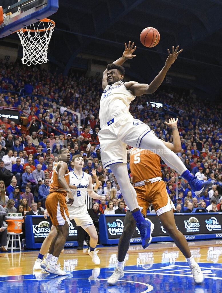 Reed Hoffmann Kansas center Udoka Azubuike (35) is fouled by Texas forward Royce Hamm Jr. (5) going for a rebound during the first half of an NCAA college basketball game in Lawrence, Kan., Monday, Feb. 3, 2020. (AP Photo/Reed Hoffmann)
