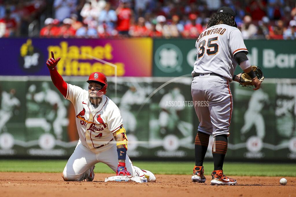 Scott Kane San Francisco Giants shortstop Brandon Crawford (35) stands near as St. Louis Cardinals' Yadier Molina gestures toward the dugout after hitting a double during the second inning of a baseball game Saturday, May 14, 2022, in St. Louis. (AP Photo/Scott Kane)
