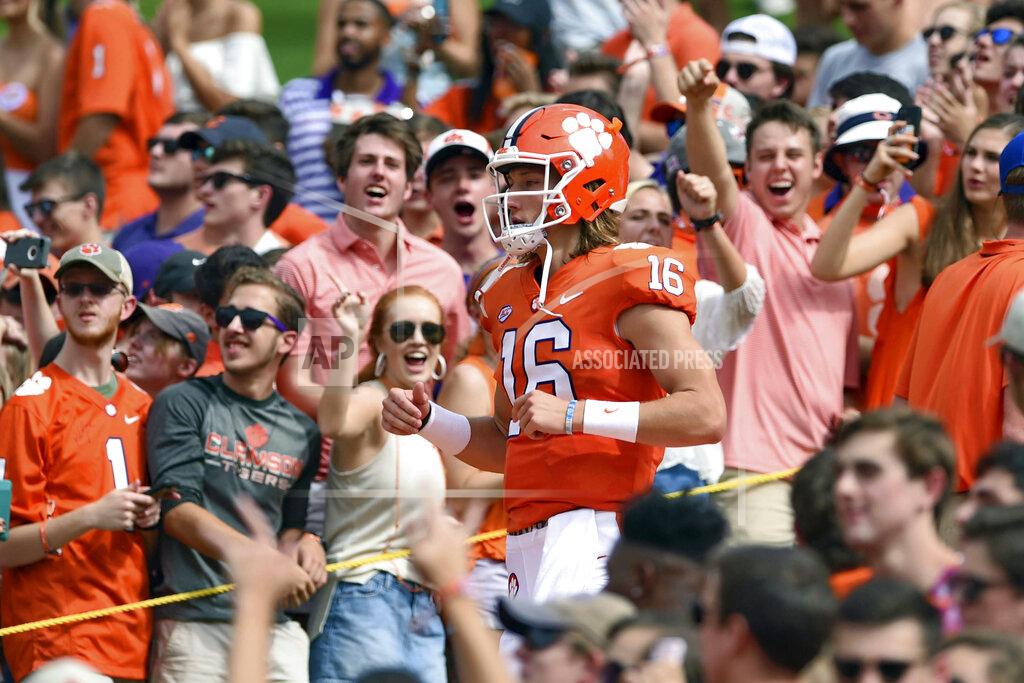 Richard Shiro FILE - In this Sept. 29, 2018, file photo, Clemson quarterback Trevor Lawrence runs down "The Hill" before the start of an NCAA college football game against Syracuse, in Clemson, S.C. For the first time, the defending national champion Tigers are No. 1 in The Associated Press preseason Top 25 presented by Regions Bank, Monday, Aug. 19, 2019. Clemson won its second national title in three seasons behind freshman quarterback Trevor Lawrence to claim equal standing with Alabama at the top of the sport. (AP Photo/Richard Shiro, File)