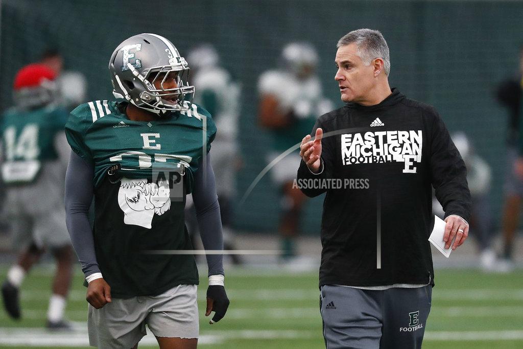 Paul Sancya Eastern Michigan football coach Chris Creighton talks with Kymani Brown during practice in Ypsilanti, Mich., Monday, Dec. 10, 2018. Eastern Michigan's football team has stepped out of the shadows created by the neighboring University of Michigan and four professional teams just down the road in the Motor City. (AP Photo/Paul Sancya)
