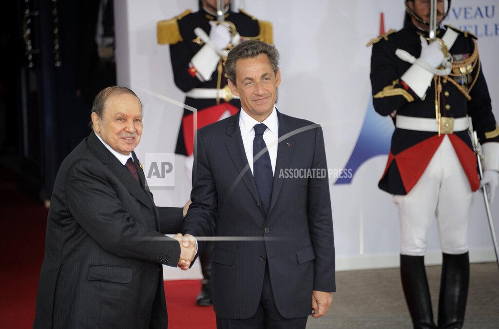 Damien Meyer FILE - In this Friday, May 27, 2011, file photo, French President Nicolas Sarkozy, right, welcomes Algerian President Abdelaziz Bouteflika prior to a round table meeting at the G8 summit in Deauville, France. Former Algerian President Bouteflika, who fought for independence from France in the 1950s and 1960s and was ousted amid pro-democracy protests in 2019 after 20 years in power, has died at age 84, state television announced Friday, Sept. 17, 2021. (Damien Meyer/Pool Photo via AP)