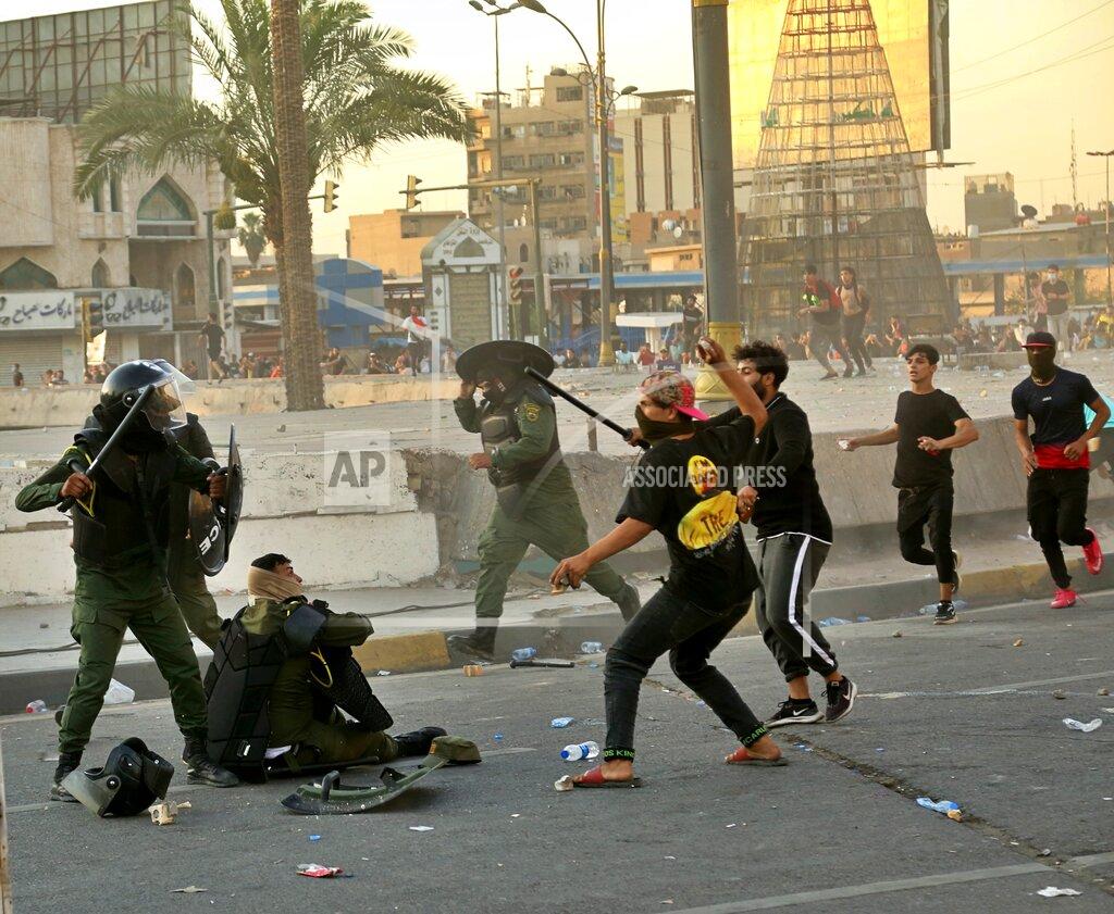 Hadi Mizban Security forces and anti-government protesters clash at Tahrir Square in Baghdad, Iraq, Tuesday, May 25, 2021. Hundreds of Iraqis took to the streets in Baghdad on Tuesday to protest what they say is impunity by those behind a rising number of targeted killings of prominent activists and journalists. (AP Photo/Hadi Mizban)