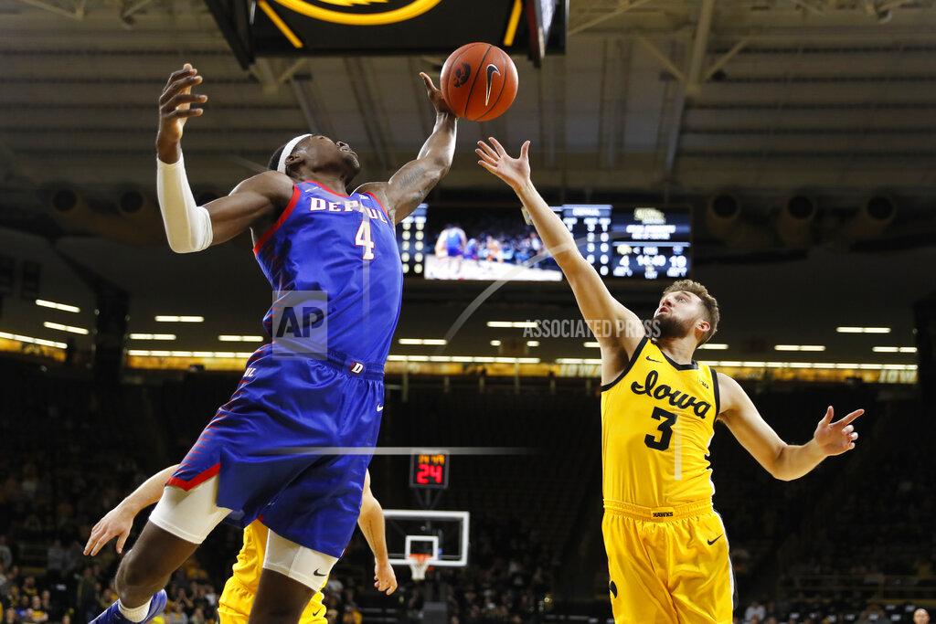 Charlie Neibergall DePaul forward Paul Reed (4) fights for a rebound with Iowa guard Jordan Bohannon (3) during the first half of an NCAA college basketball game, Monday, Nov. 11, 2019, in Iowa City, Iowa. (AP Photo/Charlie Neibergall)