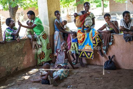 FILE - In this photo taken on Dec. 11, 2019, residents of the Malawi village of Tomali wait to have their young children become test subjects for the world's first vaccine against malaria. The U.N. health agency said Monday, Dec. 6, 2021, that the global response to the longtime threat of malaria has taken a hit as the coronavirus pandemic disrupted health services in many countries, leading to 47,000 more deaths worldwide last year – as questions remain on the possible fallout this year. The World Health Organization, in the latest edition of its World Malaria Report, cited a total of 241 million cases of malaria in 2020, up 14 million from the year before, and 627,000 deaths – an increase of 69,000.(AP Photo/Jerome Delay)