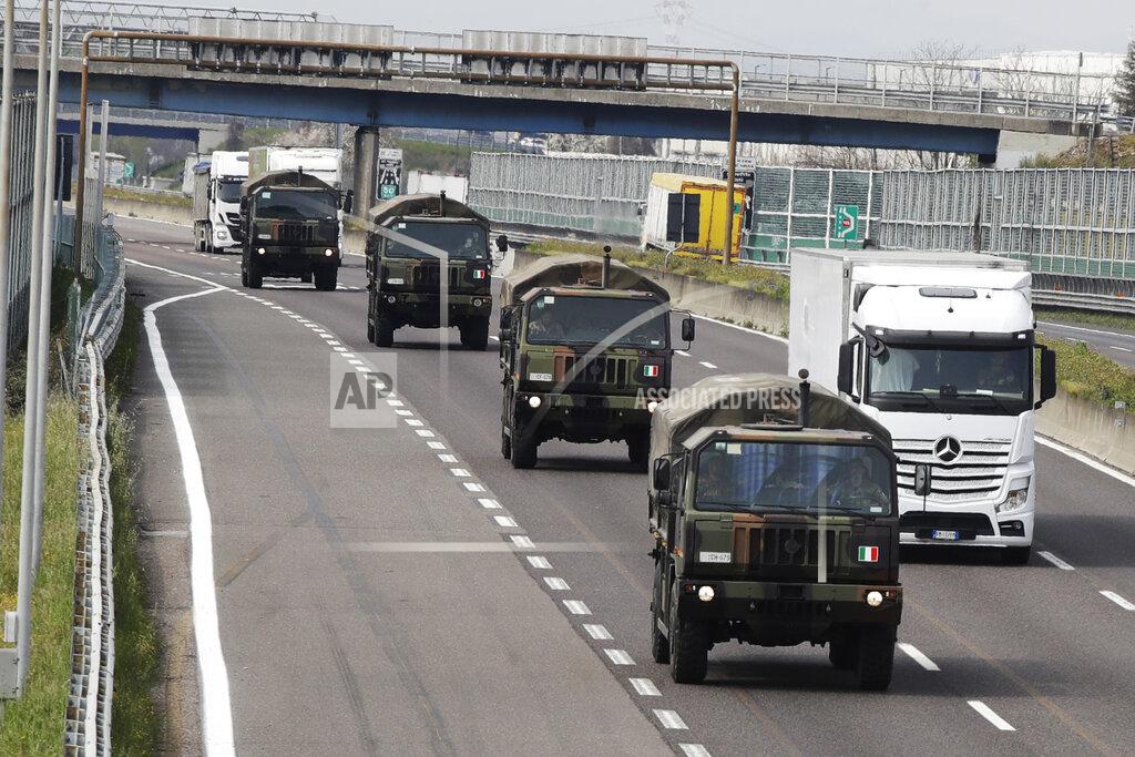 Luca Bruno FILE - In this Thursday, March 26, 2020 file photo, military trucks moving coffins of deceased people line up on the highway next to Ponte Oglio, near Bergamo, one of the areas worst hit by the coronavirus infection, on their way from Bergamo cemetery to a crematory in some other location as the local crematory exceeded its maximum capacity. Prosecutors from northern Italy have traveled to Rome Thursday, Jan. 28, 2021, to question the health minister and others as part of their broadening investigation into whether to lay any criminal blame for Italy’s horrific coronavirus toll. (AP Photo/Luca Bruno, File)
