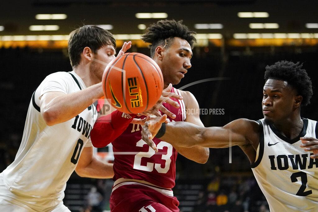 Charlie Neibergall Indiana forward Trayce Jackson-Davis (23) fights for a loose ball with Iowa forward Filip Rebraca, left, and guard Joe Toussaint, right, during the first half of an NCAA college basketball game, Thursday, Jan. 13, 2022, in Iowa City, Iowa. (AP Photo/Charlie Neibergall)