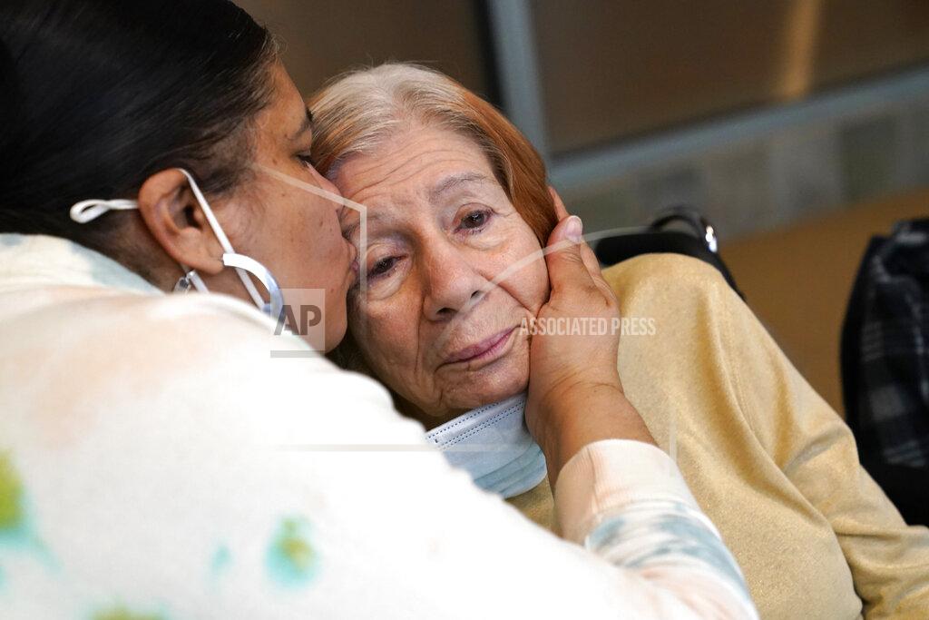 Kathy Willens FILE - Rosa DeSoto, left, embraces her 93-year-old mother Gloria DeSoto, who suffers from dementia, inside the Hebrew Home at Riverdale, Sunday, March 28, 2021, in the Bronx borough of New York. It was the first time in over a year that residents' families were allowed to enter the nursing home for in-person visits allowing physical contact among loved ones. A focus on the elderly at the start of the nation's vaccination campaign helped protect nursing homes that were ravaged at the height of the U.S. coronavirus outbreak, but they are far from in the clear. New outbreaks, often traced to infected staff members, are still occurring in long-term care centers across the country, causing continued havoc for visitation policies. (AP Photo/Kathy Willens)