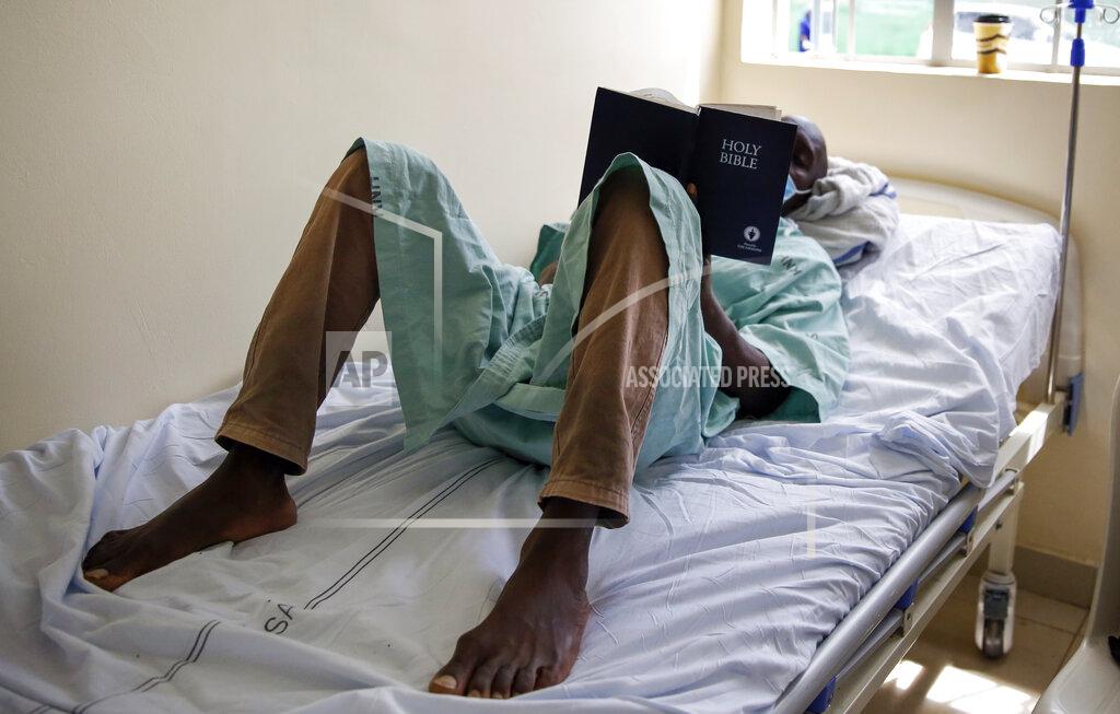 Brian Inganga FILE - In this Friday, May 1, 2020 file photo, a patient lies on his bed reading the Bible in a ward for those who have tested positive for the new coronavirus, at the infectious disease unit of Kenyatta National Hospital, located at Mbagathi Hospital, in Nairobi, Kenya. The COVID-19 pandemic is testing the patience of some religious leaders across Africa who worry they will lose followers, and funding, as restrictions on gatherings continue. (AP Photo/Brian Inganga, File)