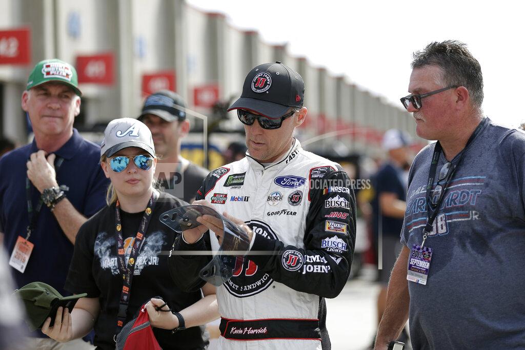 Gerry Broome Kevin Harvick signs autographs during practice for Sunday's NASCAR Cup Series auto race at Charlotte Motor Speedway in Concord, N.C., Saturday, Sept. 28, 2019. (AP Photo/Gerry Broome)