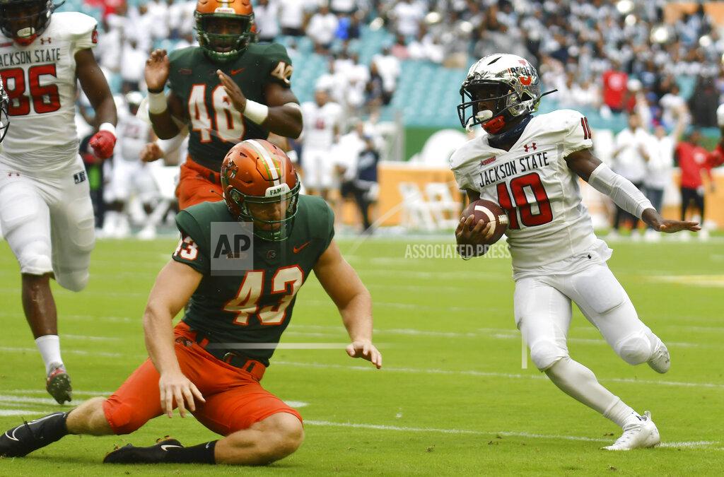 Jim Rassol Jackson State wide receiver Warren Newman (10) runs back a punt as Florida A&M punter Chris Faddoul (43) tries to make a tackle in the first quarter of an NCAA college football game, Sunday, Sept. 5, 2021, in Miami Gardens, Fla. (AP Photo/Jim Rassol)