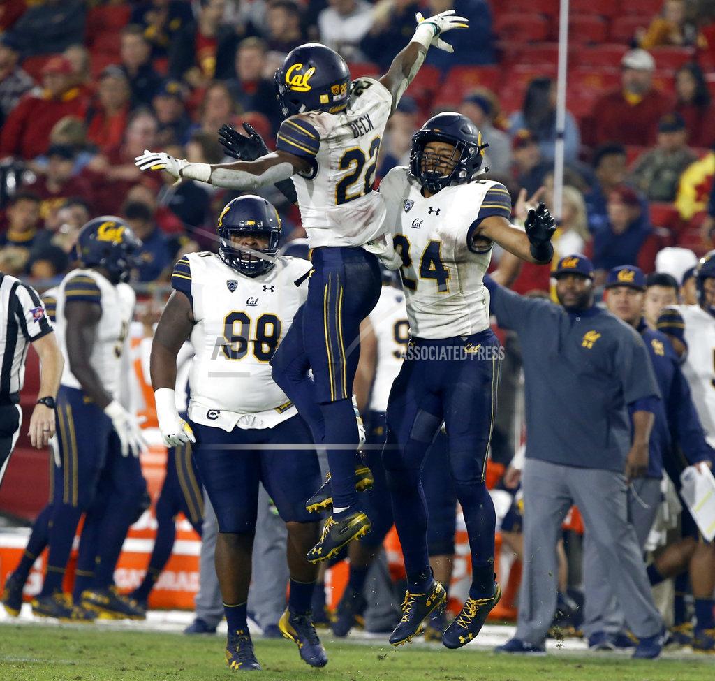 Alex Gallardo California cornerback Traveon Beck (22) celebrates his interception with cornerback Camryn Bynum (24), with nose tackle Chris Palmer (98) watching during the second half of an NCAA college football game against Southern California in Los Angeles, Saturday, Nov. 10, 2018. California won 15-14. (AP Photo/Alex Gallardo)