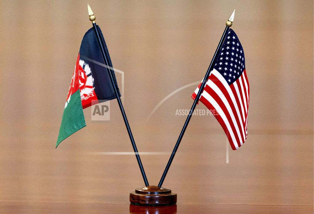 Alex Brandon FILE - The flags of Afghanistan and the United States are seen on the table before a meeting at the Pentagon in Washington, June 25, 2021. The United States has taken control of Afghanistan's embassy in Washington and the country's consulates in New York and California. The State Department says it had assumed “sole responsibility” for the security and maintenance of the diplomatic missions effective on Monday and will bar anyone from entering them without its permission. The move came after the department said the embassy and consulates had “formally ceased conducting diplomatic and consular activities in the United States.” (AP Photo/Alex Brandon, File)