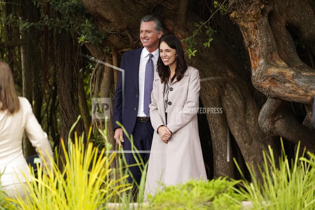 Eric Risberg California Gov. Gavin Newsom and New Zealand Prime Minister Jacinda Ardern pose for pictures by a tree after an event at the San Francisco Botanical Garden in San Francisco, Friday, May 27, 2022. Newsom met with Ardern in Golden Gate Park "to establish a new international partnership tackling climate change." (AP Photo/Eric Risberg)