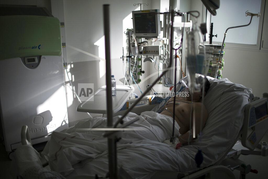 Daniel Cole A sixteen-year-old patient suffering from COVID-19 rests after being transferred to an ICU room at the La Timone hospital in Marseille, southern France, Tuesday Feb. 2, 2021. COVID patients occupy 88% of the Marseille region's intensive care beds, and virus pressure on French hospitals is steadily rising in recent weeks despite curfews and other restrictions. (AP Photo/Daniel Cole)