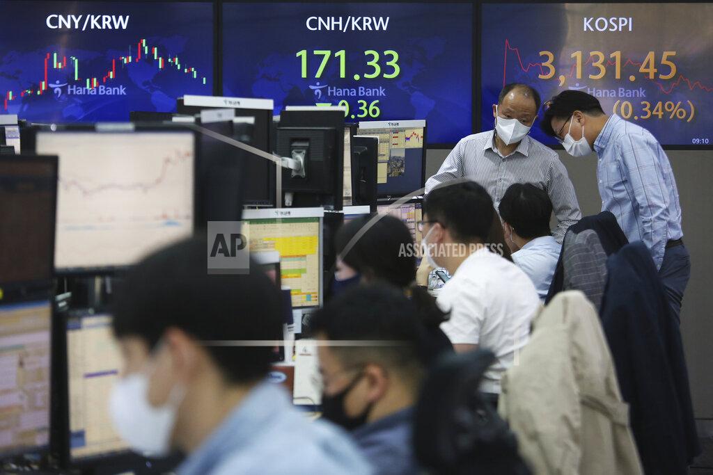 Ahn Young-Joon Currency traders wearing face masks work at the foreign exchange dealing room of the KEB Hana Bank headquarters in Seoul, South Korea, Tuesday, April 6, 2021. Asian shares were mixed Tuesday after a Wall Street rally that reflected some optimism about the economy recovering from the damage of the coronavirus pandemic. (AP Photo/Ahn Young-joon)