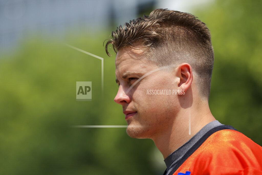 Aaron Doster Cincinnati Bengals' Joe Burrow walks to the field before NFL football practice in Cincinnati, Wednesday, July 28, 2021. (AP Photo/Aaron Doster)