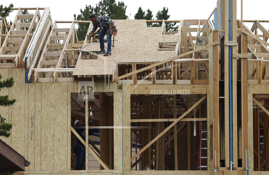 Workers toil on a multifamily dwelling Tuesday, Aug. 4, 2020, in Winter Park, Colo. The Commerce Department reported Tuesday, Aug. 18, construction of new U.S. homes surged 22.6% last month as homebuilders continued to bounce back from the coronavirus pandemic. (AP Photo/David Zalubowski)