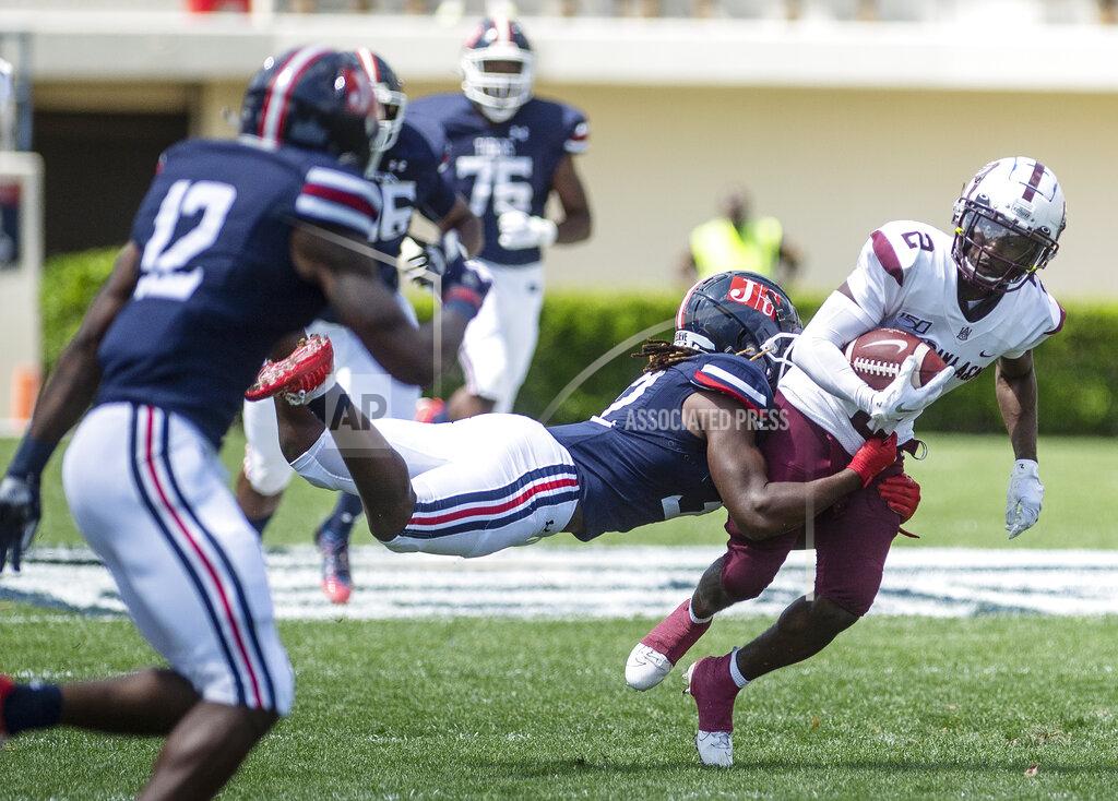 Jackson State's Javien Adams (32) tries to stop Alabama A&M's Brian Jenkins Jr. (2) during an NCAA college football game, Saturday, April 10, 2021, at Veterans Memorial Stadium in Jackson, Miss. (Eric Shelton/The Clarion-Ledger via AP)