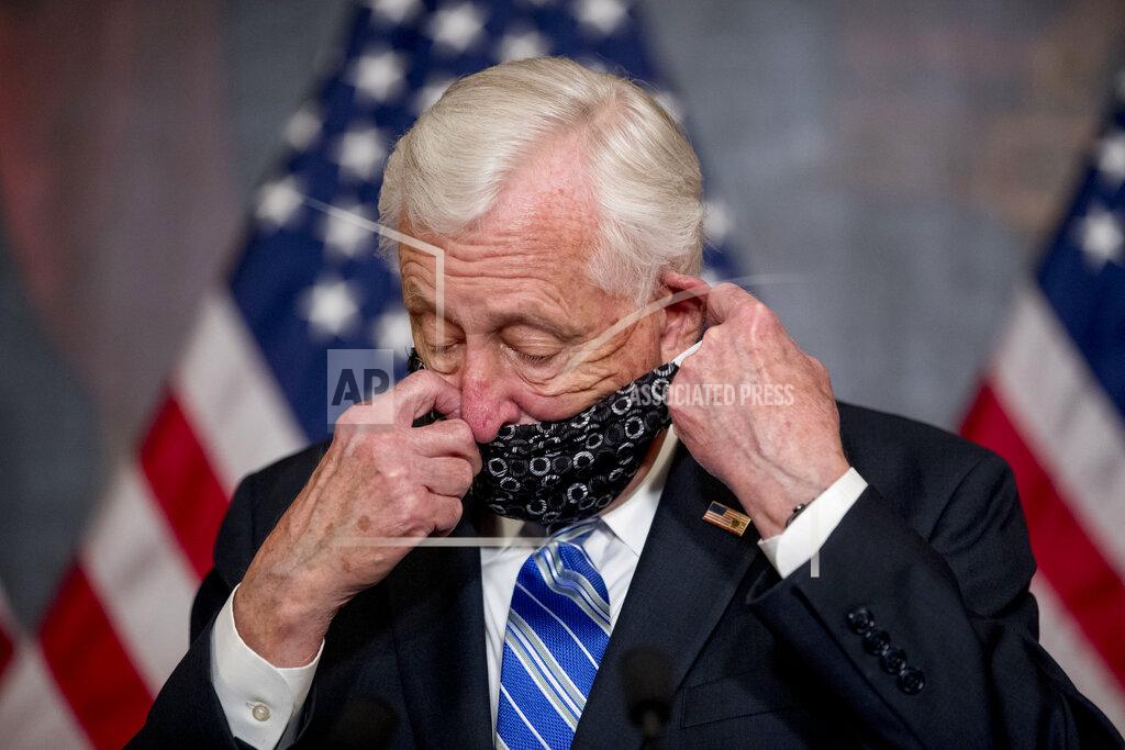 Andrew Harnik FILE - In this April 23, 2020, file photo, House Majority Leader Steny Hoyer of Md. takes his mask off to speak before the signing ceremony for the Paycheck Protection Program and Health Care Enhancement Act, H.R. 266, after it passed the House on Capitol Hill in Washington. It all started with the grandchildren. As Hoyer saw it, if he could Face Time with his grandkids, why not have Congress legislate by video chat and avoid the health risks of convening at the Capitol during the coronavirus pandemic. (AP Photo/Andrew Harnik, File)