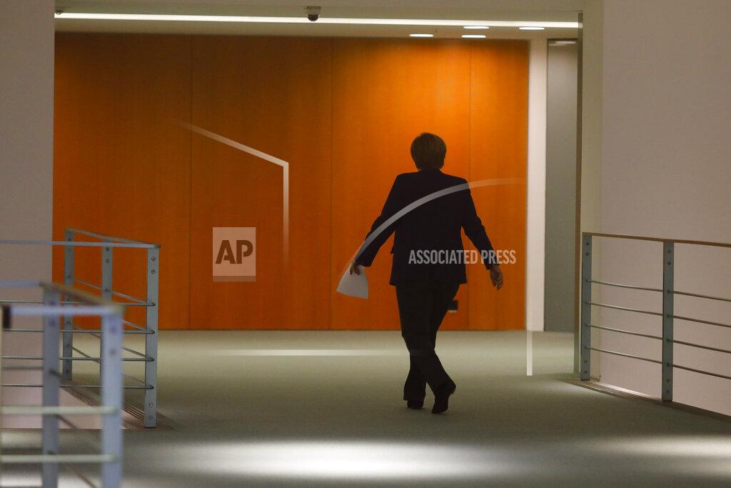 Markus Schreiber File - In this Wednesday, Dec. 2, 2020 file photo, German Chancellor Angela Merkel arrives for a news conference following talks of the government with the federal state governors, at the Chancellery in Berlin, Germany. German Chancellor Angela Merkel's center-right party, the Christian Democratic Union, CDU, is choosing a new leader on the weekend Saturday Jan. 16 and Sunday Jan. 17, 2021, a decision that will help determine who succeeds Merkel at the helm of the European Union's biggest economy after a 16-year reign. Merkel, now 66, has steered Germany, and Europe, through a series of crises since she took office in 2005, she said over two years ago that she won't seek a fifth term as chancellor. (AP Photo/Markus Schreiber, Pool, file)