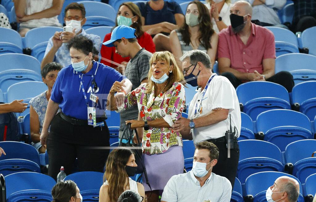 Rick Rycroft A spectator is escorted from Rod Laver Arena by security during the second round match between Spain's Rafael Nadal and United States' Michael Mmoh at the Australian Open tennis championship in Melbourne, Australia, Thursday, Feb. 11, 2021.(AP Photo/Rick Rycroft)
