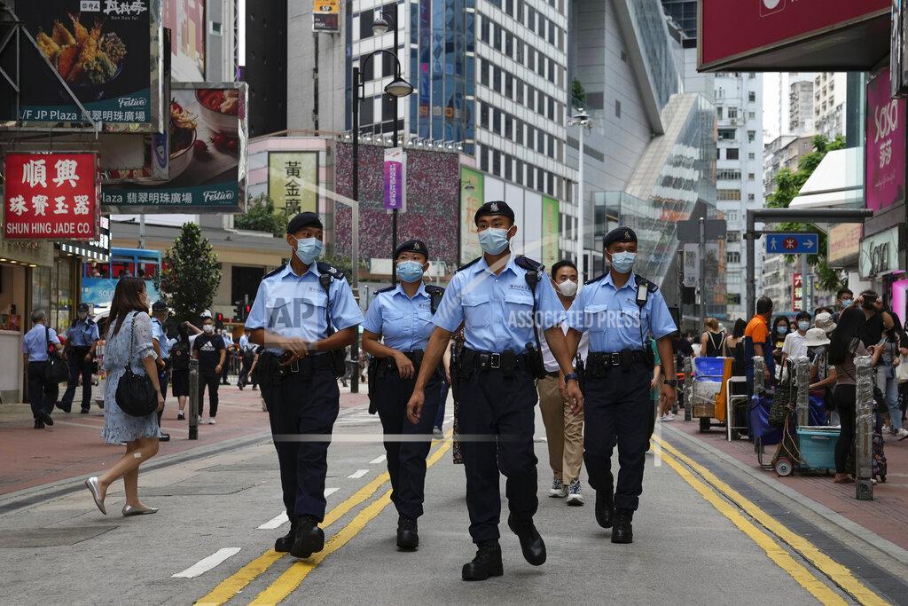 Kin Cheung Police officers patrol near the Victoria Park in Hong Kong, Friday, June 4, 2021. Police arrested an organizer of Hong Kong's annual candlelight vigil remembering the deadly Tiananmen Square crackdown and warned people not to attend the banned event Friday as authorities mute China's last pro-democracy voices. In past years, tens of thousands of people gathered in Hong Kong's Victoria Park to honor those who died when China’s military put down student-led pro-democracy protests on June 4, 1989. Hundreds, if not thousands were killed. (AP Photo/Kin Cheung)