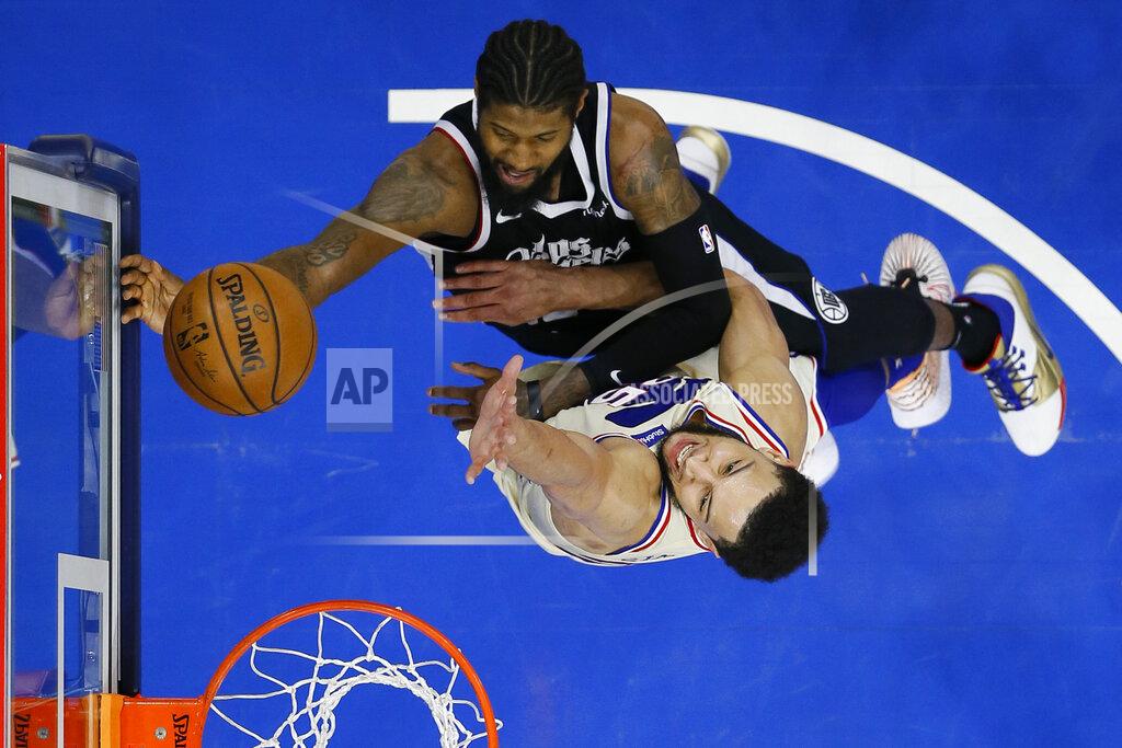Matt Slocum Los Angeles Clippers' Paul George, top, goes up for a shot against Philadelphia 76ers' Ben Simmons during the second half of an NBA basketball game, Friday, April 16, 2021, in Philadelphia. (AP Photo/Matt Slocum)