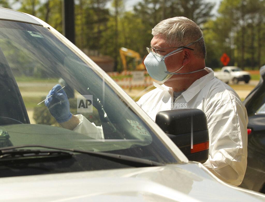 Thomas Wells Friendship Medical Clinic employee Kevin Parks gets ready to administer a Covid-19 test at their clinic in Ecru, Miss., Friday, April 3, 2020. (Thomas Wells/The Northeast Mississippi Daily Journal via AP)