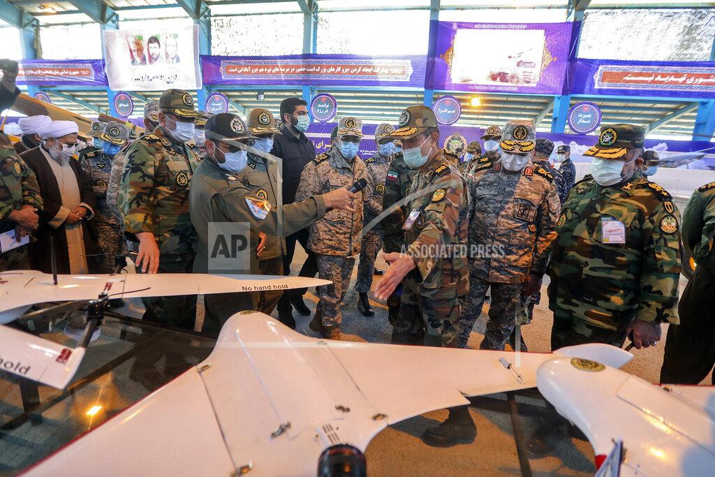 Uncredited In this photo released Tuesday, Jan. 5, 2021 by the Iranian army, Chief of the General Staff of the Armed Forces Gen. Mohammad Hossein Bagheri, center, listens to an explanation while visiting at a display of drones prior to a drill, Iran. The Iranian military on Tuesday began a wide-ranging, two-day aerial drill in the country's north, state media reported, featuring combat and surveillance unmanned aircraft, as well as naval drones dispatched from vessels in Iran's southern waters. (Iranian Army via AP)