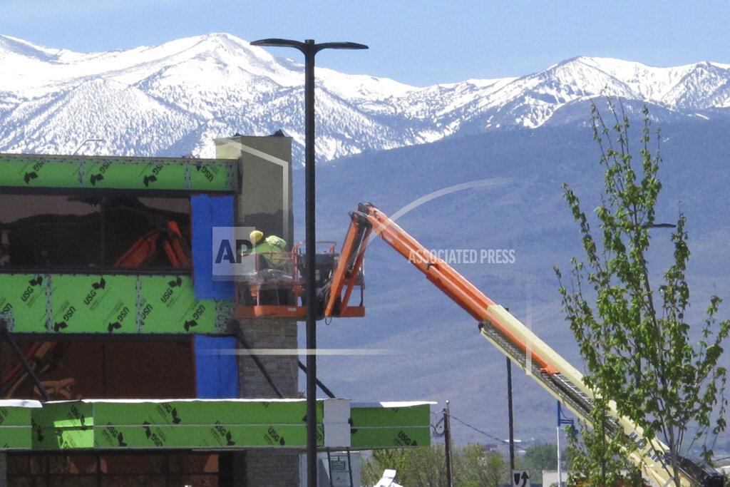 Scott Sonner A construction worker works on the exterior of the Legends Bay Casino, Friday, May 13, 2022, in Sparks, Nev. The new casino is scheduled to open this summer at The Outlets at Legends shopping center along I-80 next to the Sparks Marina. It will be the first new casino built in the Reno-Sparks area in a quarter-century. Las Vegas-based Circa Sports will operate the sports book inside Olympia Gaming's 80,000-square-foot casino, which also will include table games, slots and video poker. (AP Photo/Scott Sonner)