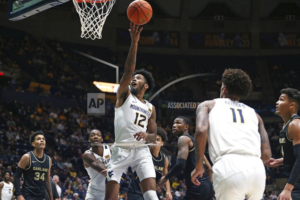 Kathleen Batten West Virginia guard Taz Sherman (12) shoots against Oakland during the second half of an NCAA college basketball game in Morgantown, W.Va., Tuesday, Nov. 9, 2021. (AP Photo/Kathleen Batten)